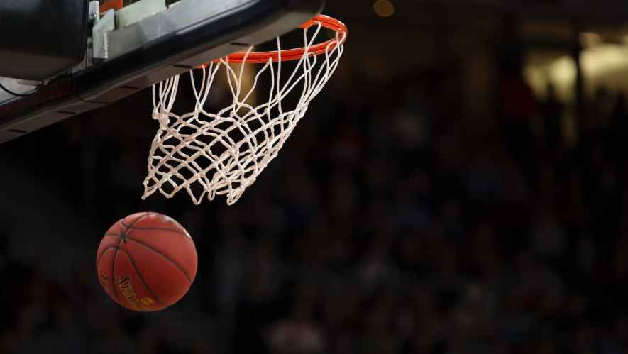 A basketball swooshing through a net