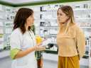 A pharmacist helping a woman in a pharmacy