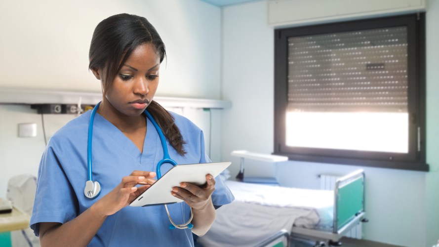 Female doctor looking a tablet - healthcare technology