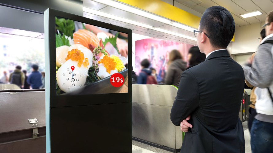 man looking at an AI smart digital advertising billboard that is suggesting sushi to him
