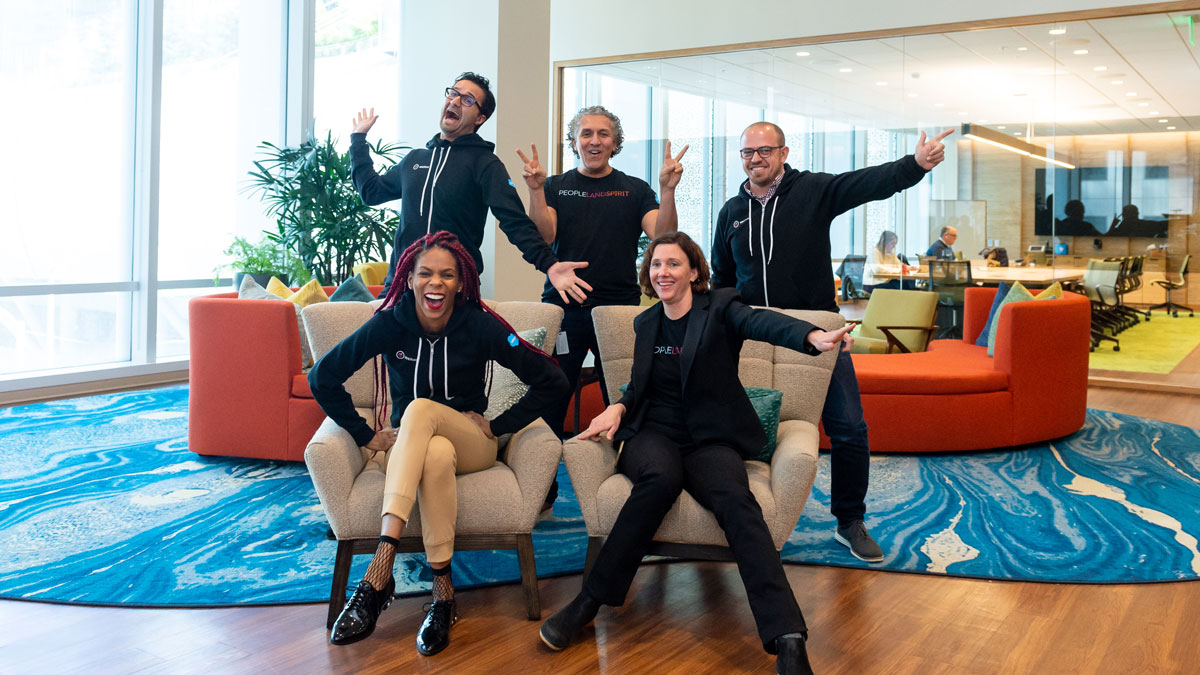 5 WINDforce members (2 in front and 3 in back posing) in a group photo at the Salesforce Tower building in San Francisco.