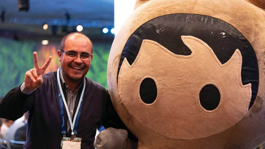 a Dreamforce attendee next to the Salesforce character, Astro