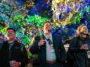 Three Dreamforce attendees watch the event, which includes sales hacks tips
