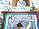 A man stands below a MuleSoft sign: What is MuleSoft