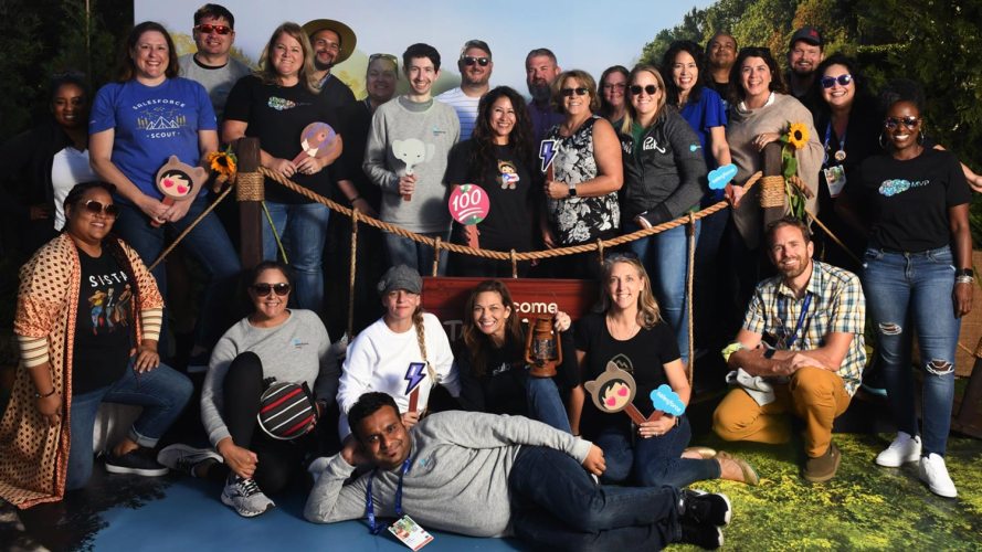 A group of 20 or so Trailblazers posing at at pretend swingbridge during a Dreamforce event.