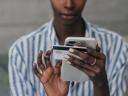 woman holding both her smartphone and credit card: digital process automation