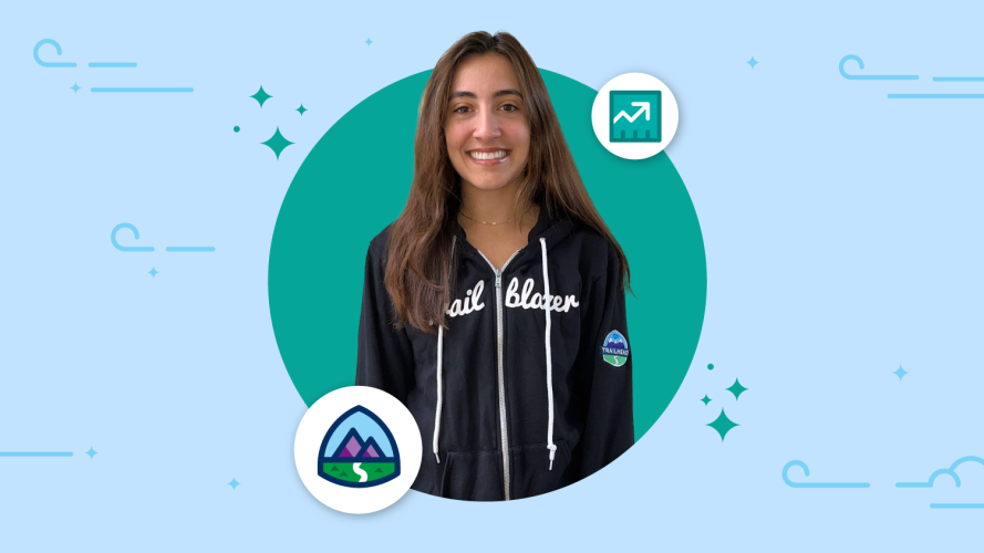Image of a Trailblazer in a black hoodie with a Trailhead logo and Sales Cloud icon