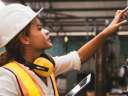 Woman in hardhat checking utility panel: utilities field service management