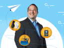 Certified Instructor, Brian Richardson, standing against a blue background with a paper plane flying past three Trailhead Marketing Cloud badges