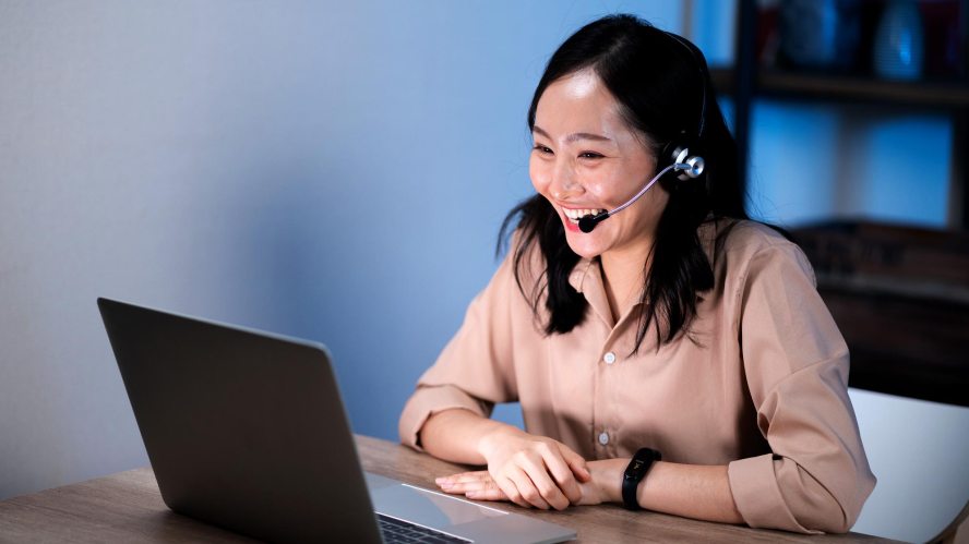 customer service agent is smiling wearing a headset: automation employee experience customer experience job satisfaction