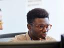 A man looking at a computer screen with a colleague. Data correlation.