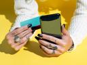 hands with tattooed fingers and black nail polish holding a smartphone and credit card: business success business growth