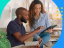 Sales coaching: Two salespeople looking at a tablet