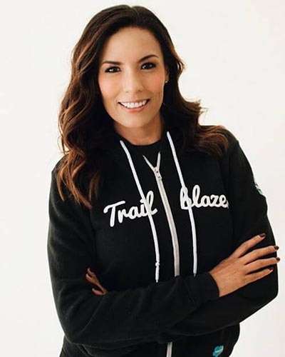 Photo of Paula Arango wearing a hoodie that says: "Trailblazer"