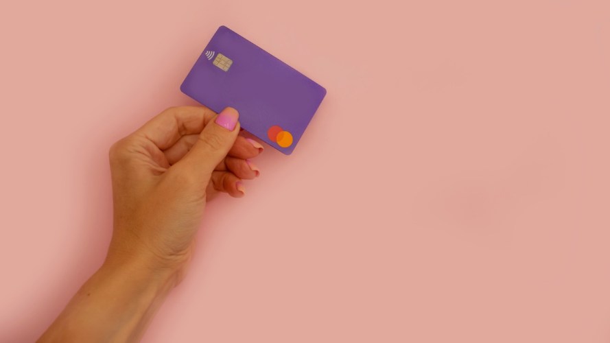 A woman's hand holding a credit card