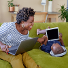 woman and child sitting on a couch with their computers