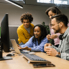 group of people sitting in front of a computer