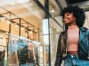 A young woman looks through a store window: Millennials vs. Gen Z