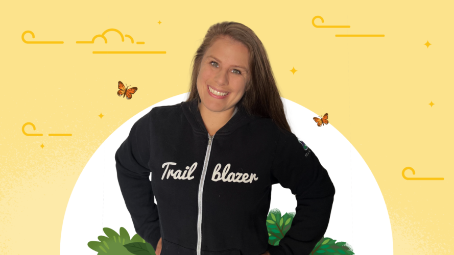 Trailblazer Jessica Johnson standing with her hands on her hips in an iconic black Trailblazer hoodie against a bright yellow background