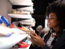 A field rep sets up an in-store display of shoes: retail execution solutions