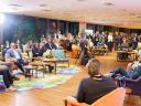 A group of people sitting down and talking