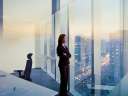A woman who symbolizes the modern CFO looks out of a window in her office.