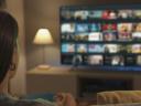 A woman sees a selection of programs on her TV
