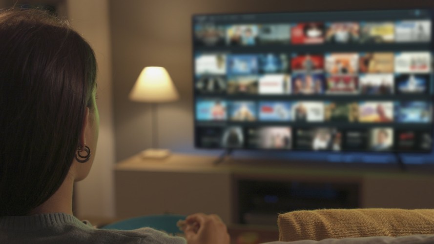 A woman sees a selection of programs on her TV