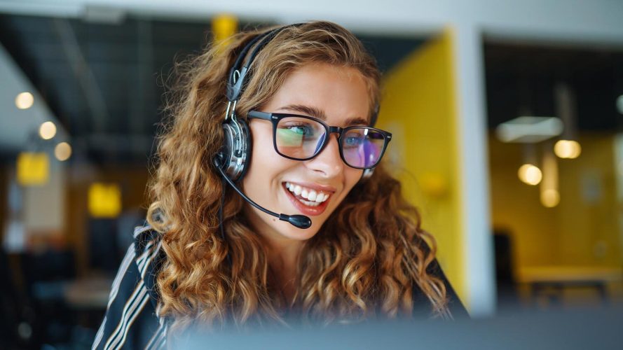 A sales rep speaks to a prospect using a headset: sales tech stack