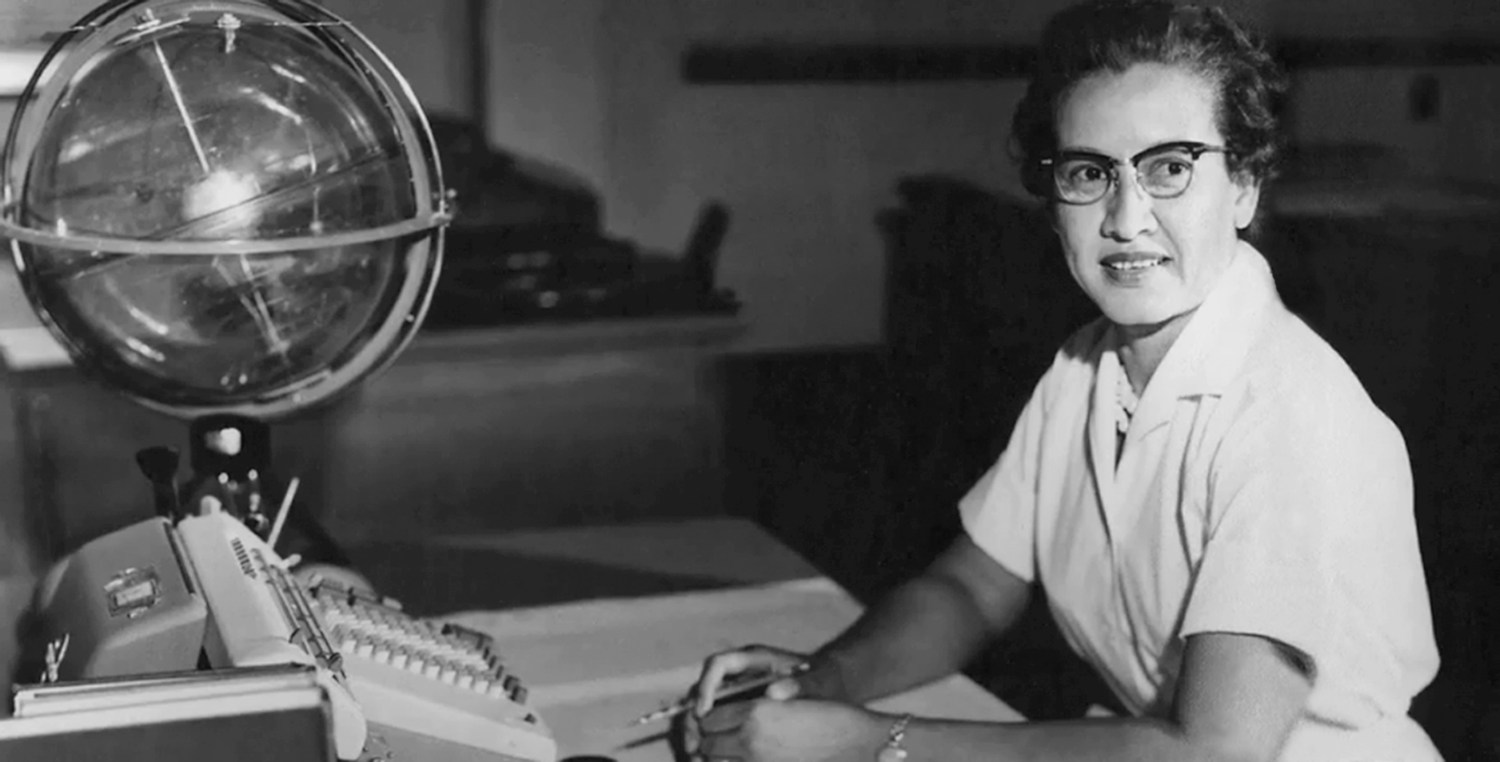 NASA space scientist and mathematician Katherine Johnson poses for a portrait at her desk.