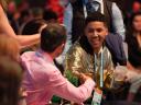 Photo of two people shaking hands at Salesforce Connections, one of which is wearing a gold Trailblazer hoodie