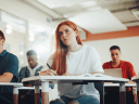 Image of woman studying in a classroom setting / Cybersecurity Learning Hub: Addressing the Global Workforce Gap Through Education