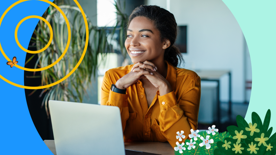 A seller sits in front of a laptop and smiles after learning how to get a job in sales.