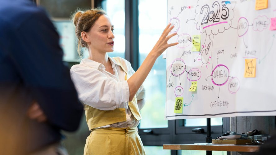 An image of a woman at a whiteboard