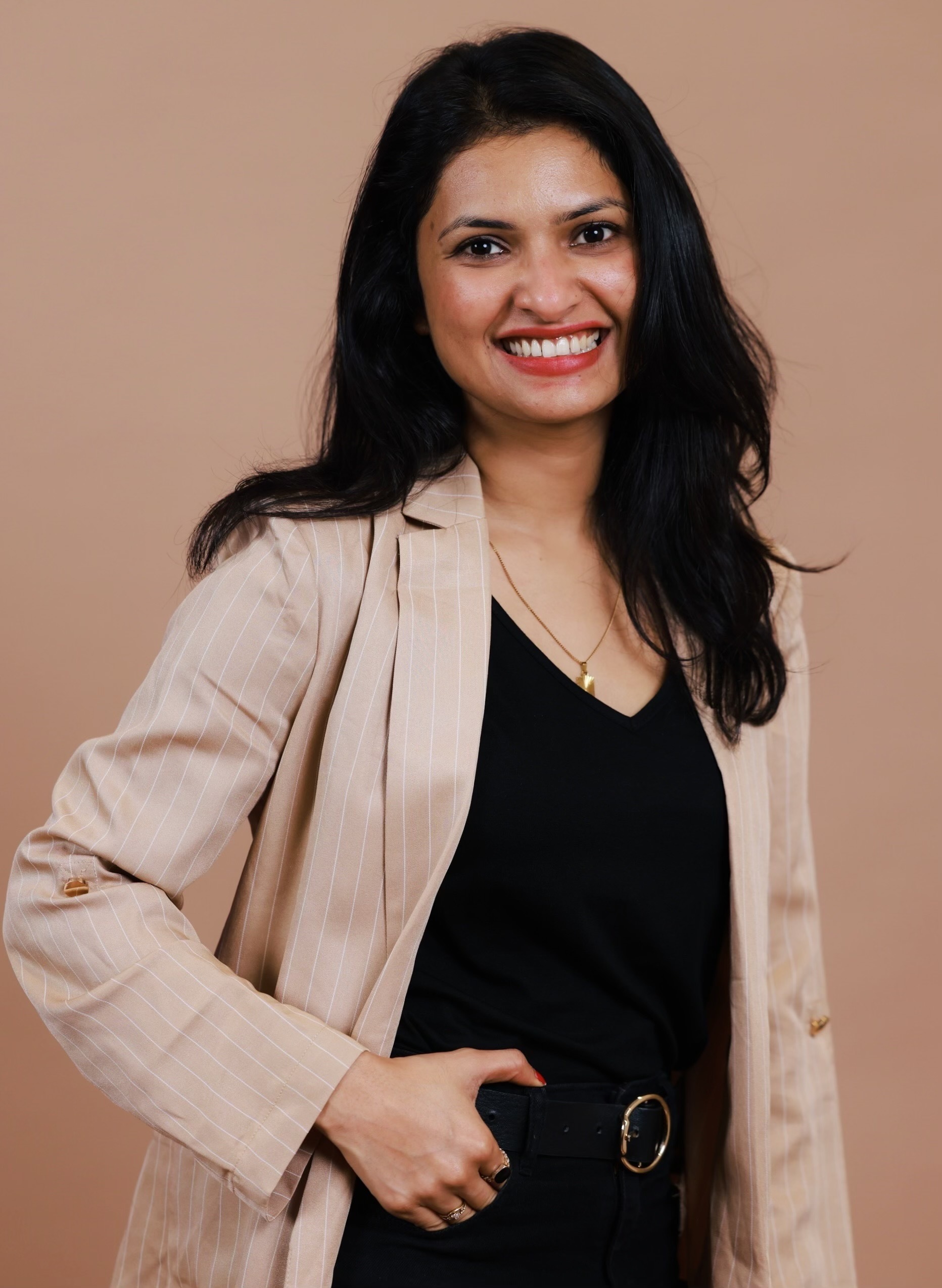 Praisy Abraham smiling at the camera.