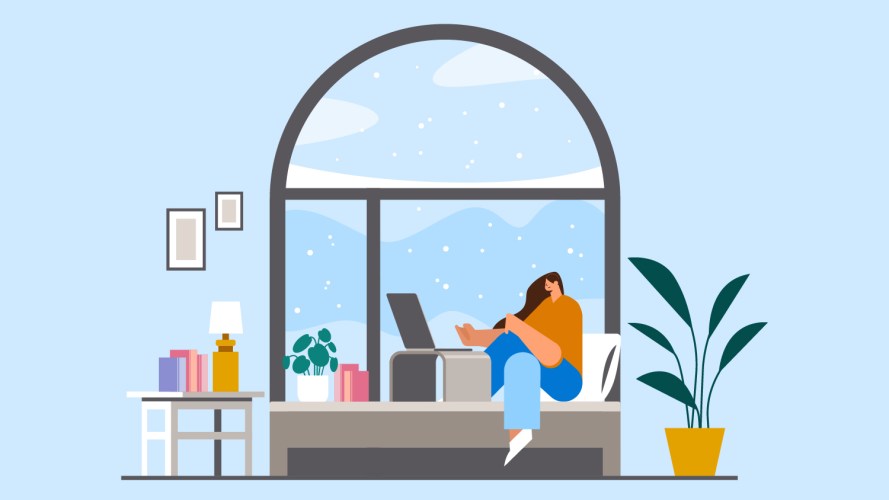 A person sits on a window seat and shops from her laptop while snow falls outside: retail automation