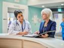 A doctor in a hospital goes over a treatment plan with a female patient / healthcare personalization strategies