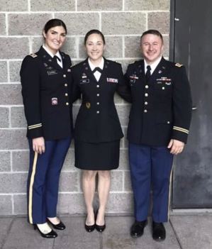 Hanna, middle, with her Captain’s Career Course classmates in 2021, smile and pose together for a picture.