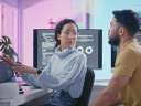 A female programmer talking with her male coworker at a desk in the office / software development lifecycle