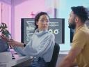 A female programmer talking with her male coworker at a desk in the office / software development lifecycle