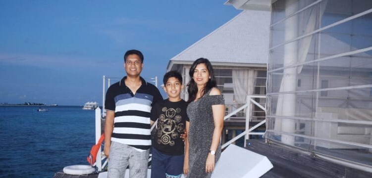 Shraddha Tirthali with her family smiling and posing for a picture