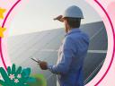 A mobile worker stands next to solar panels, shielding his eyes while looking toward the sun and a bright future.