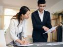 Two women reviewing a business proposal for SMB over a desk.