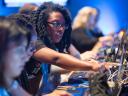 People learning at computers during a Salesforce event.