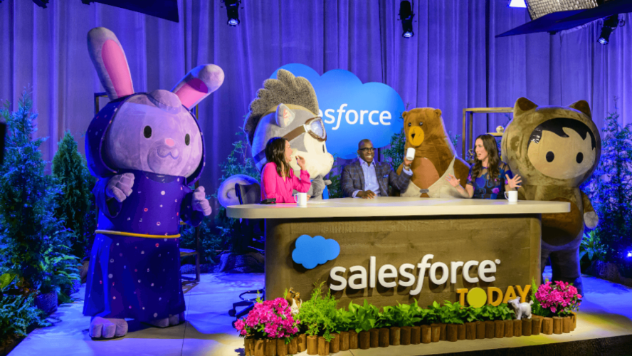 Salesforce characters gather around broadcast desk with panelists