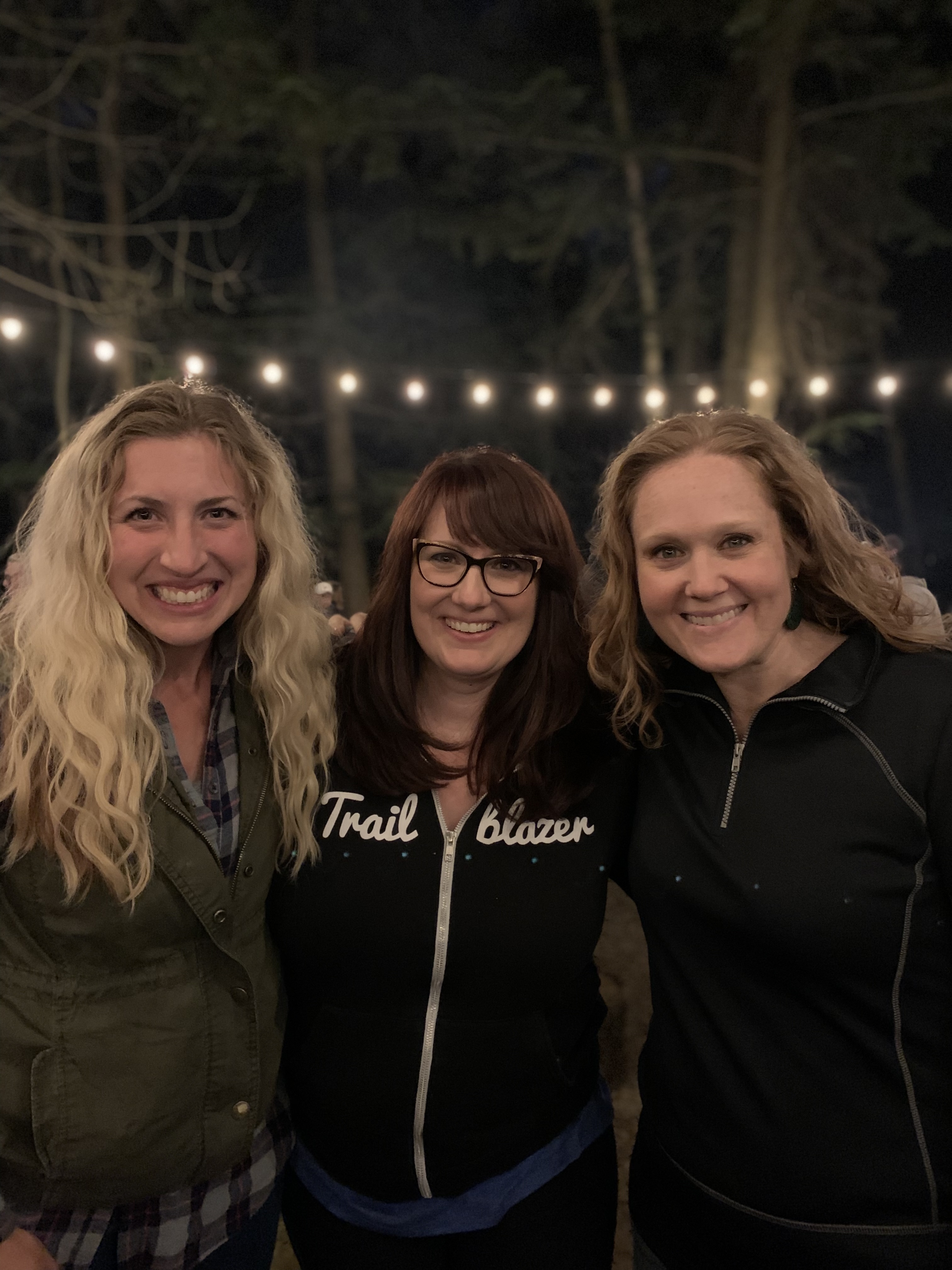 Tina, center, rocking her Trailblazer hoodie at a concert with her best friends.