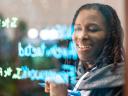 Woman writing "Well-Architected Framework" on a lightboard.