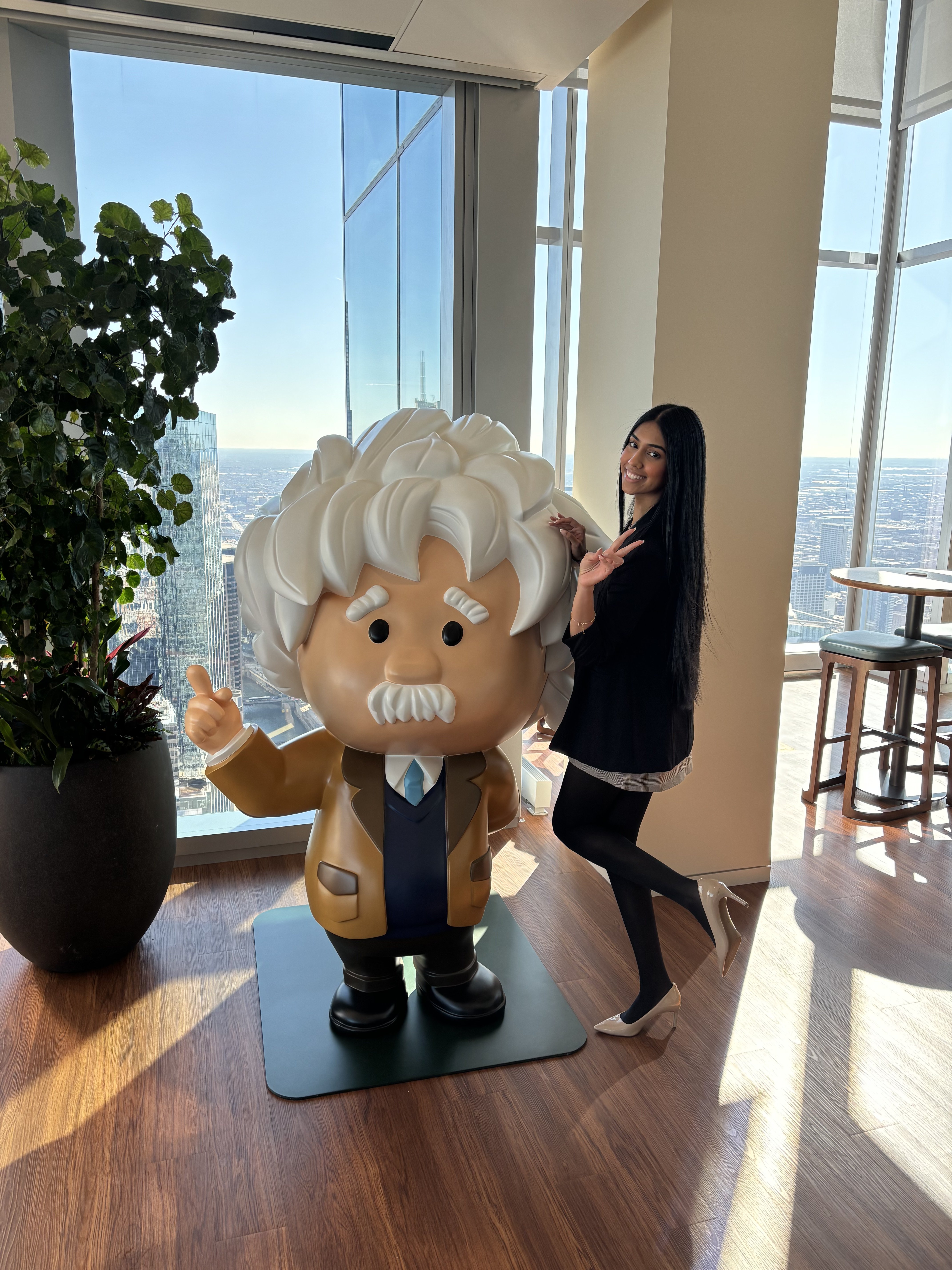 Simran, a Sales Development Representative, poses with Einstein in the Toronto office