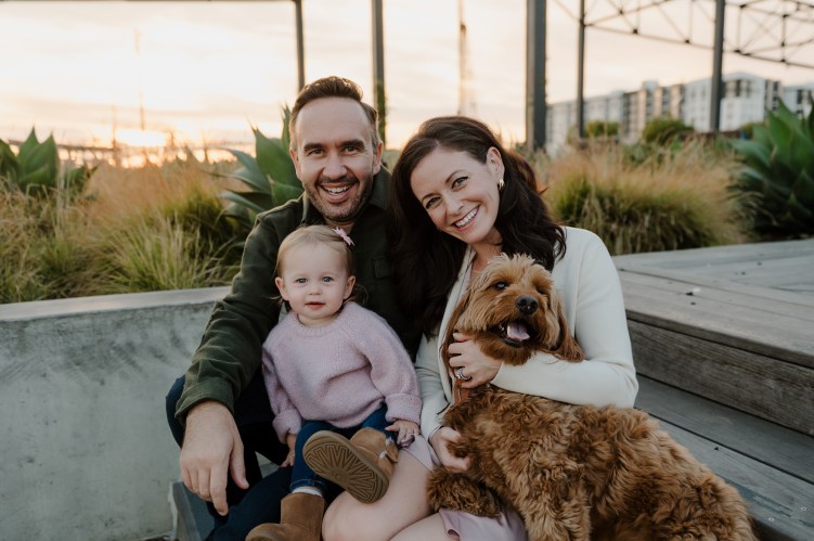 Rachel Winn posing next to her family and her dog
