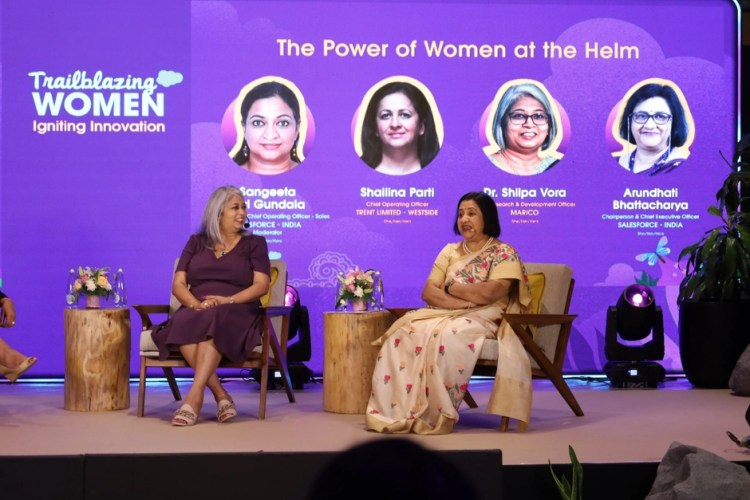 Two women on stage speaking at the Trailblazing Women Summit India event.